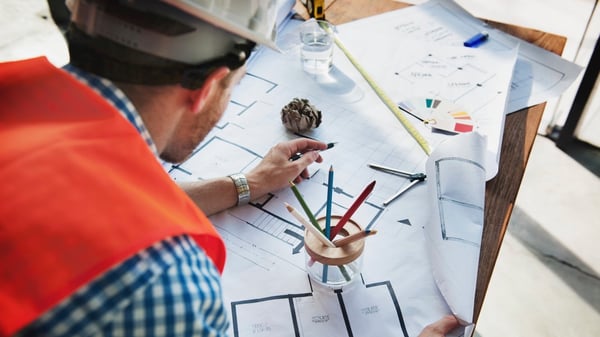 Construction worker looking at a blueprint